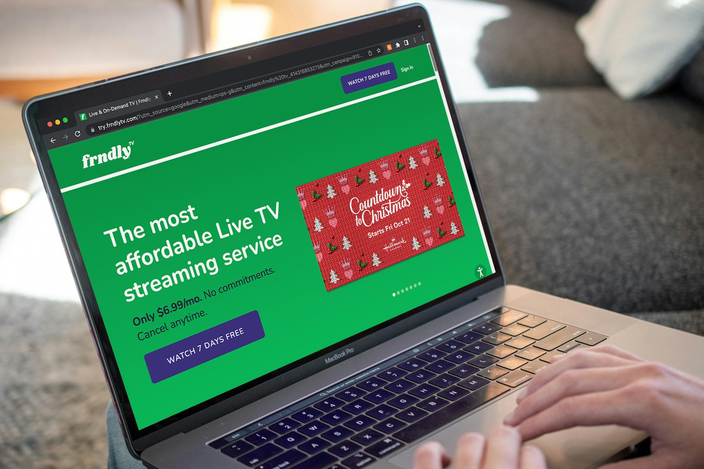 Someone using a laptop looking at the Frndly page advertising the Hallmark Countdown to Christmas