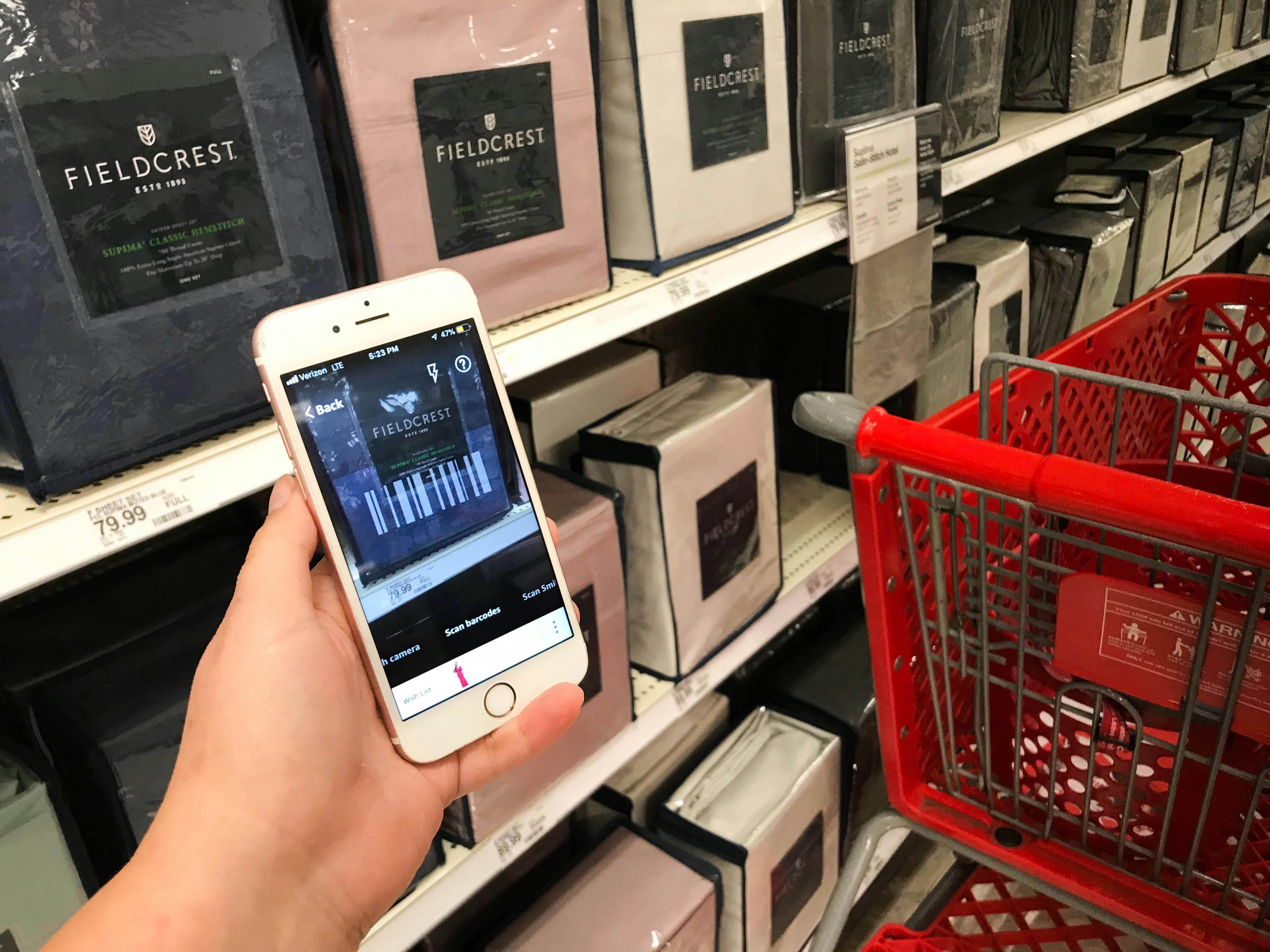 Someone holding a phone in the bedding aisle at Target