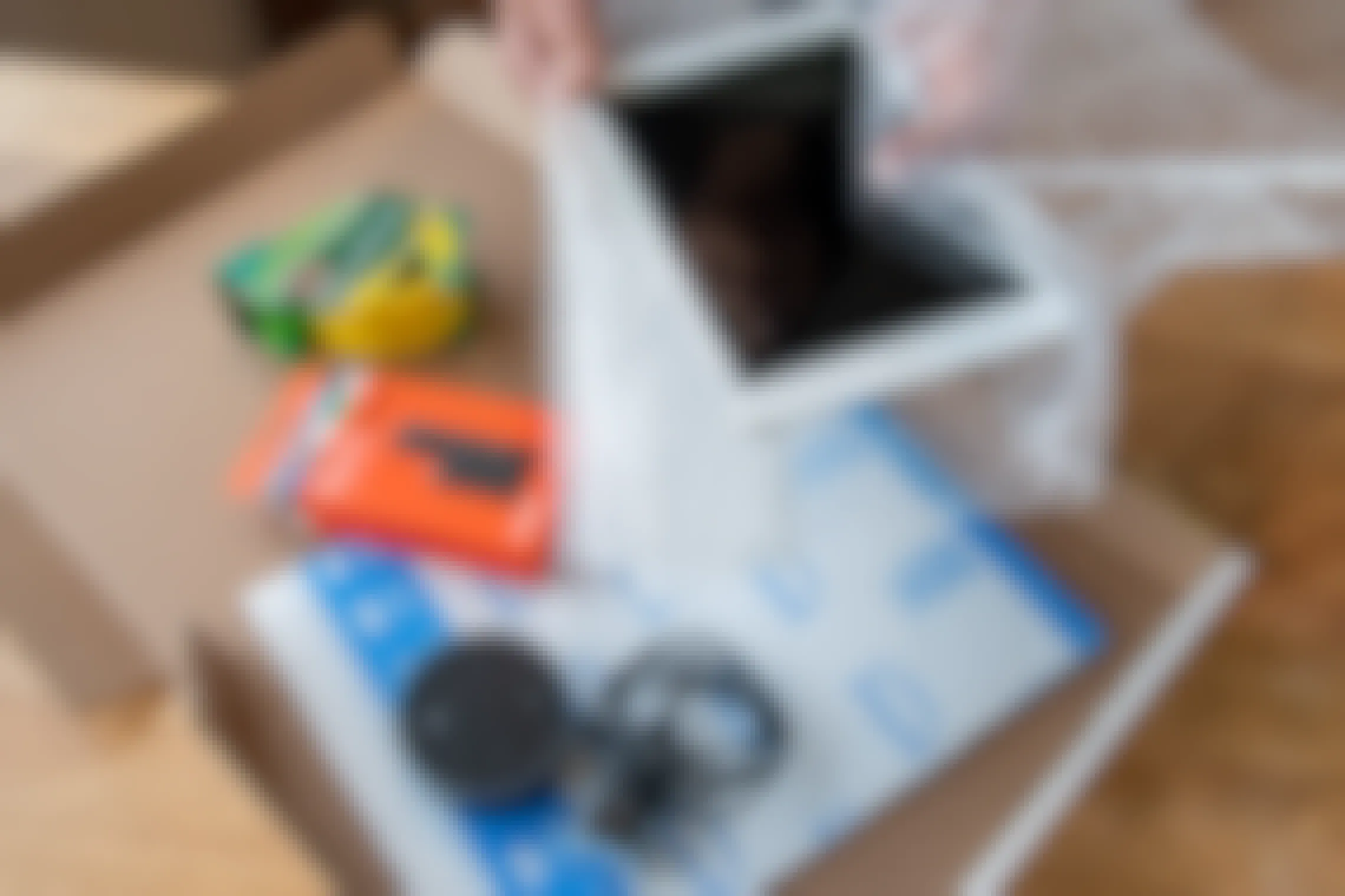 An iPad, Amazon Fire stick, and Amazon Echo dot being boxed up to ship.