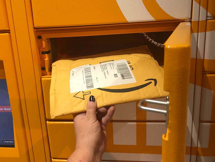 an amazon package being put into an amazon locker 