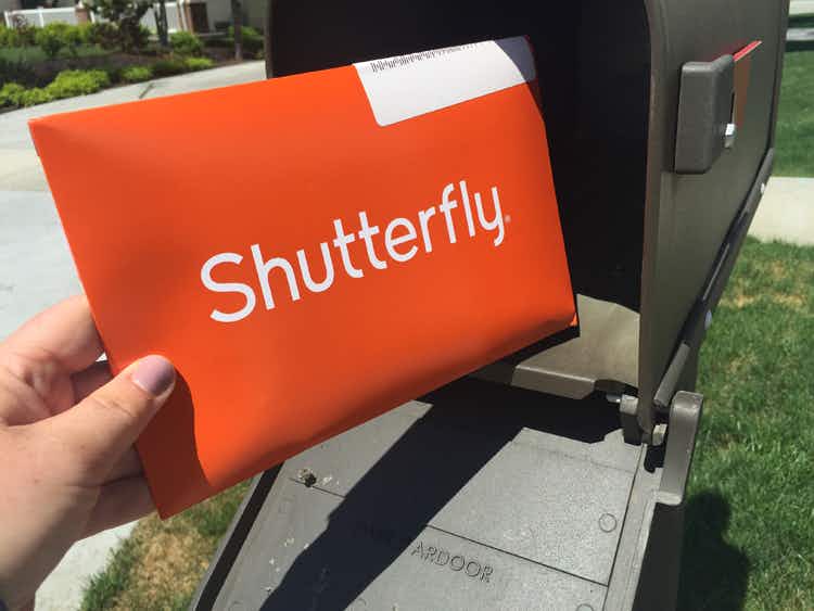 someone with shuttefly package at mailbox