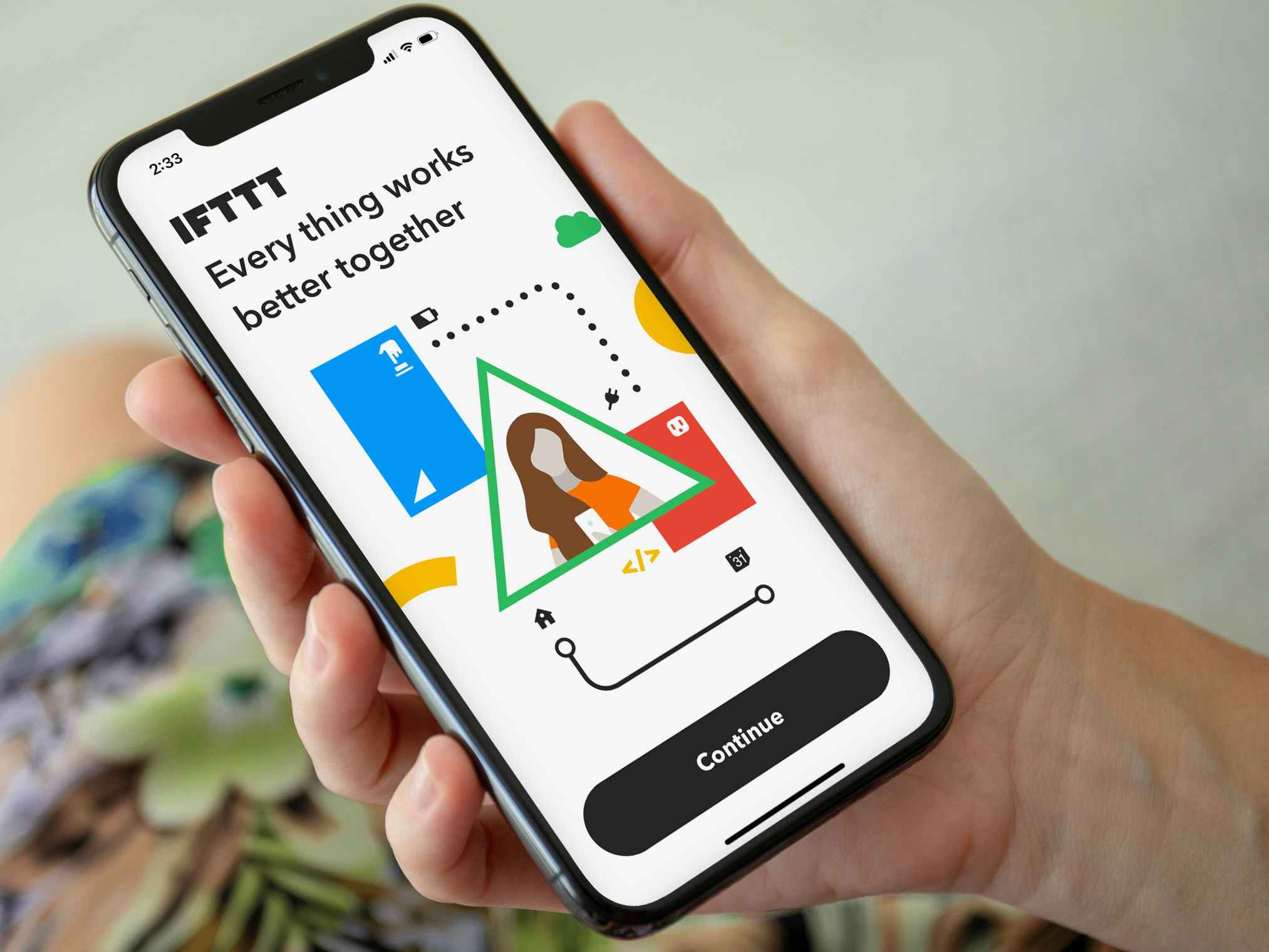 Someone looking at the IFTTT app on their phone