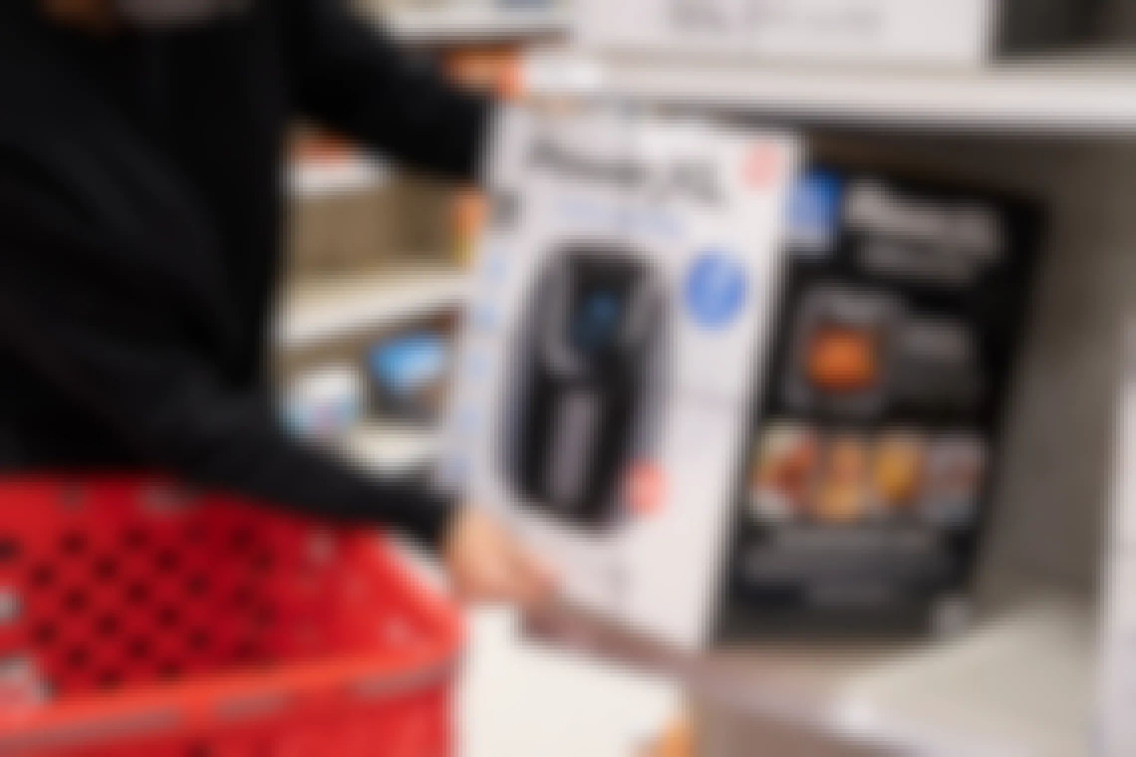 Person pulling an air fryer off a shelf in Target
