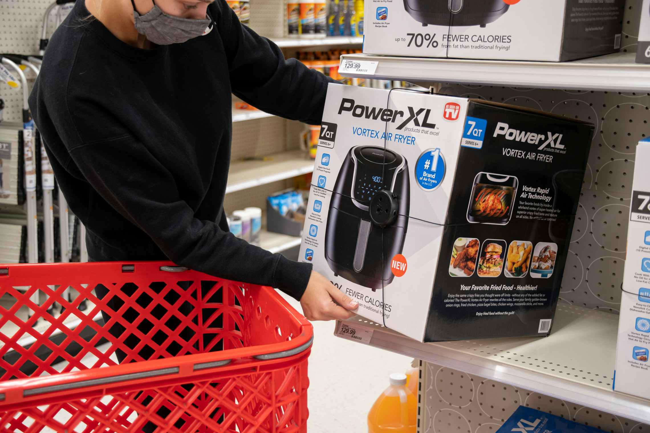 Person pulling an air fryer off a shelf in Target