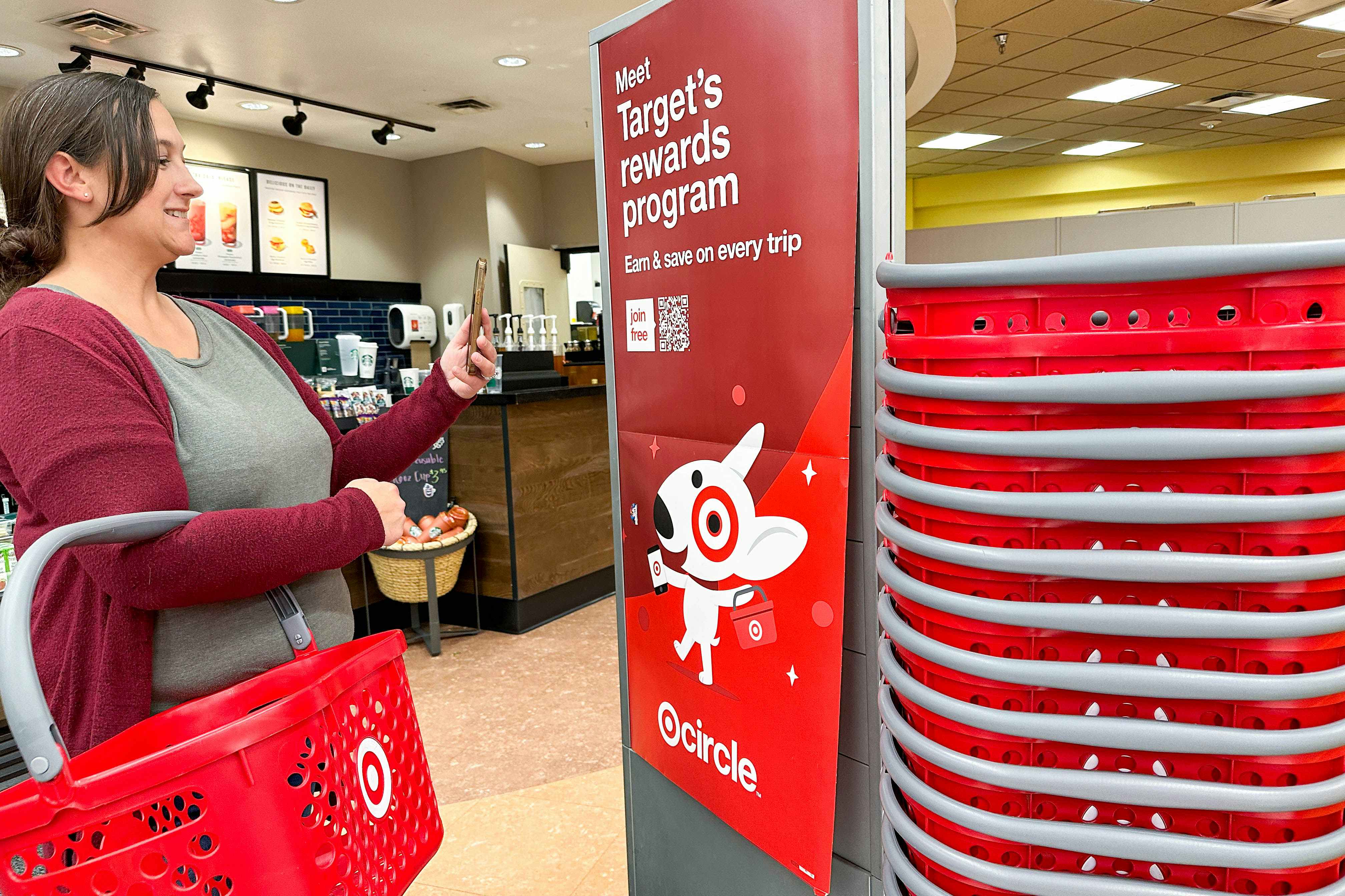 a woman scanning qr code on target signage 