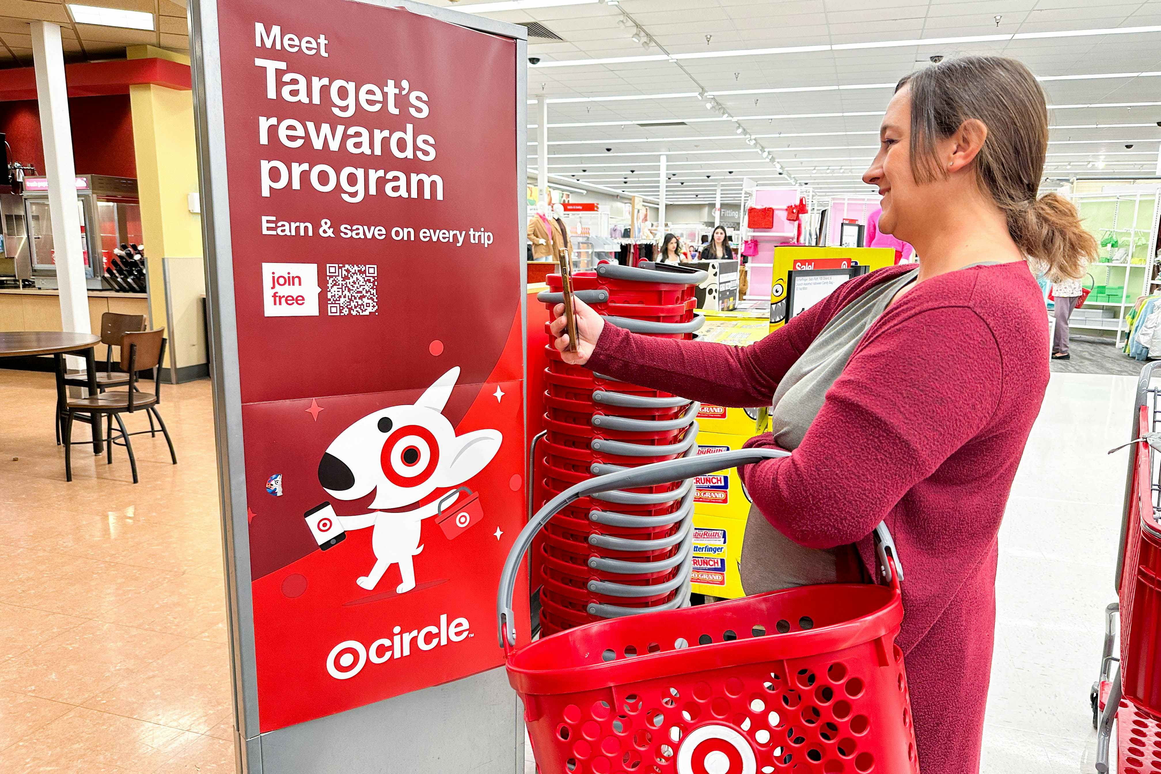 a woman scanning qr code on target signage