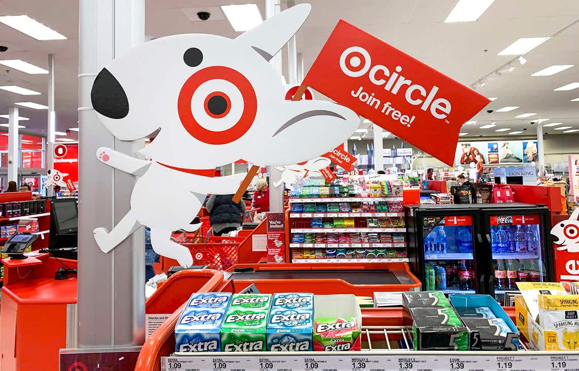 A sign at a Target checkout lane of the Target dog with a flag advertising Target Circle.