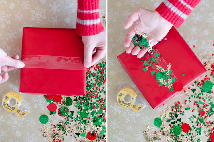 A gift box with double sided tape on the front, having confetti sprinkled on it.