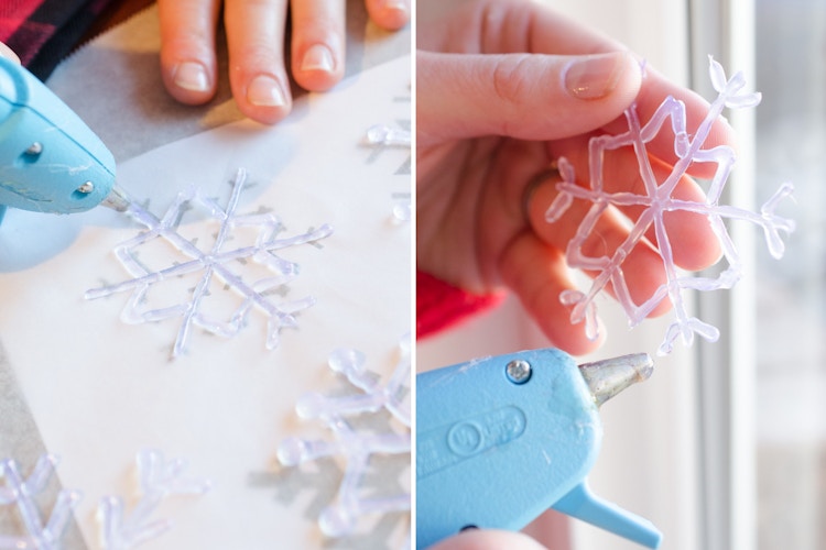 A person making snow flakes with a hot glue gun.