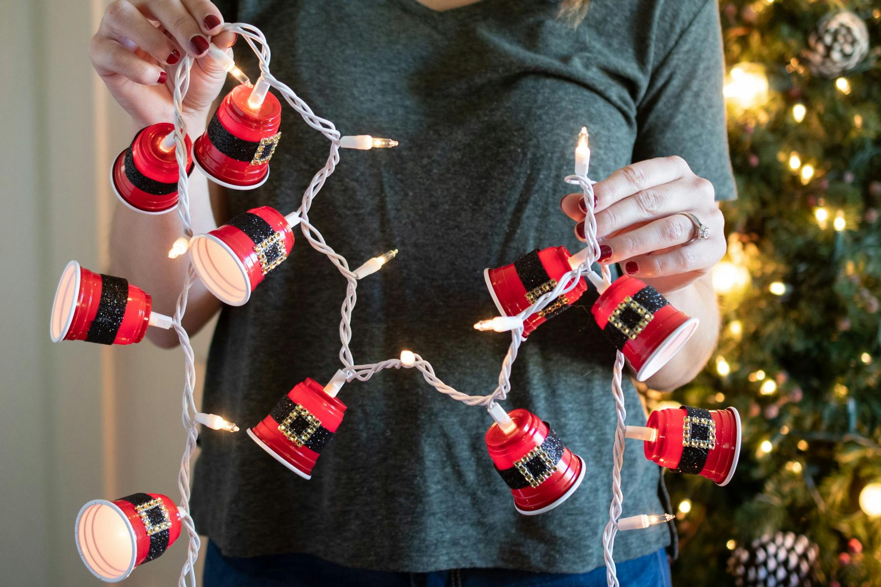 A strand of Christmas lights with DIY Santa, red party cups attached. 