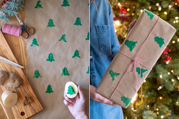 A person using a potato with a Christmas tree shape cut out of it to stamp green Christmas trees onto brown paper, making their own wrapping paper.