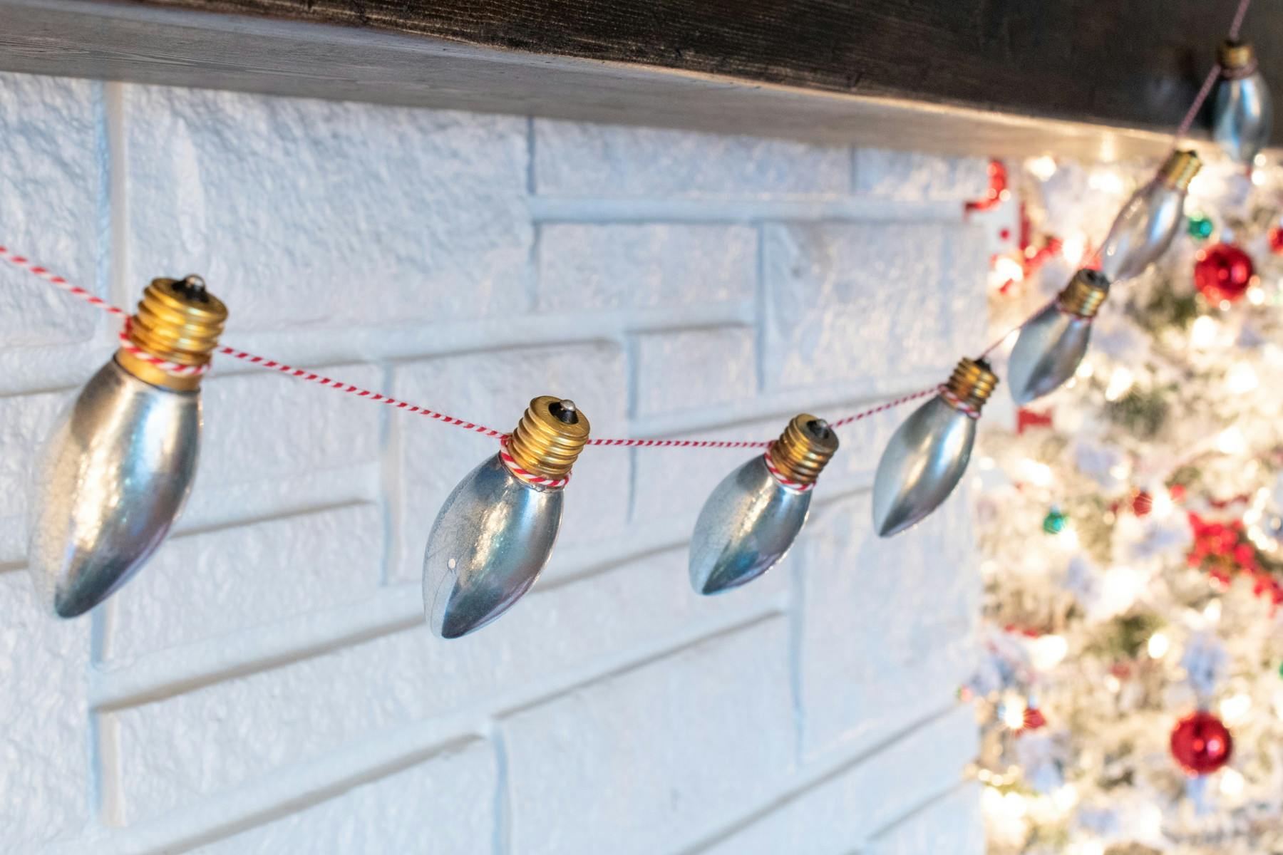 Christmas light bulbs, sprayed with a glass paint finish, tied onto a string to make a garland