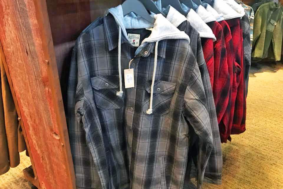 Some flannel jackets hanging on a rack inside Cabela's.