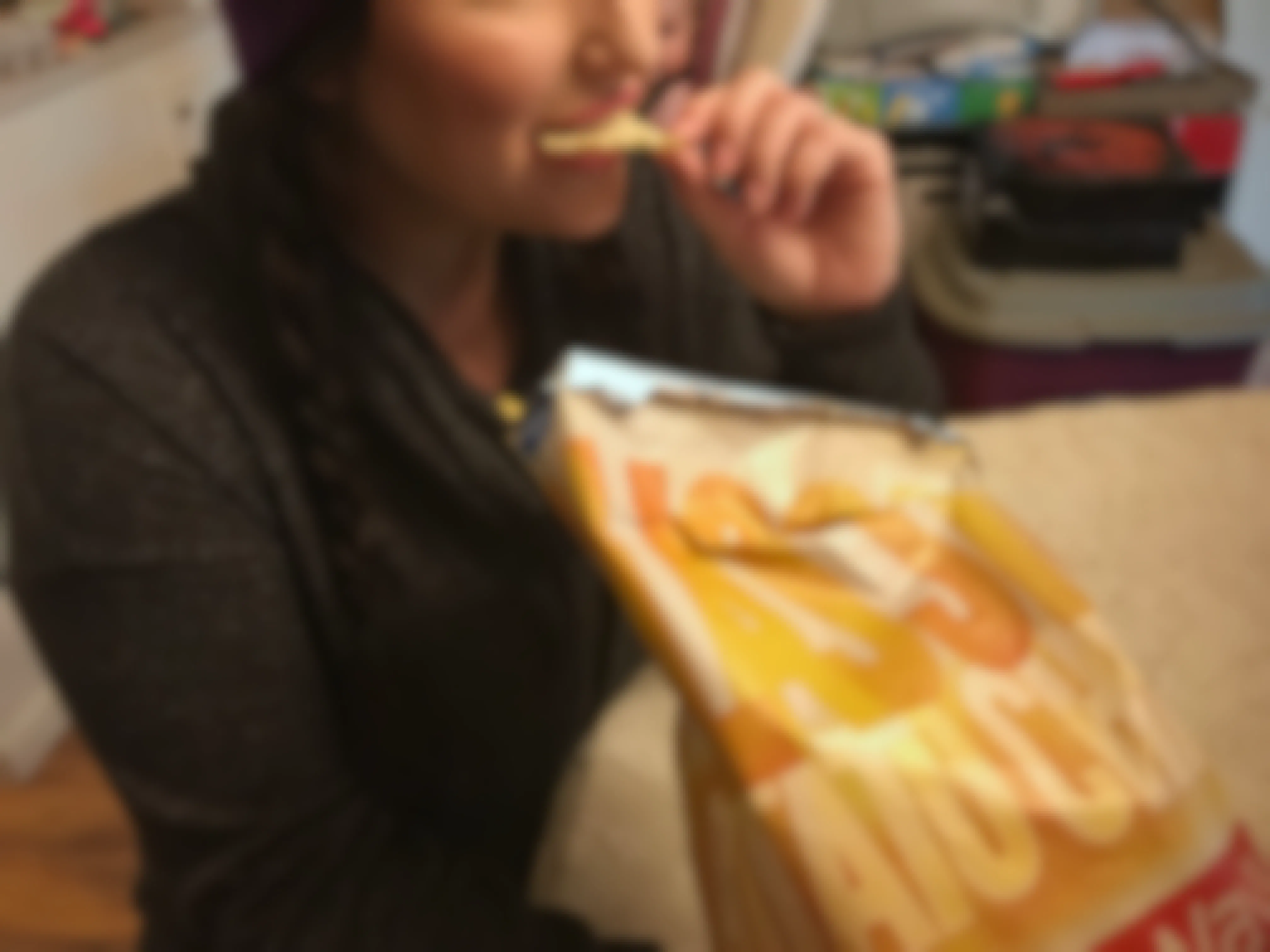 A person eating chips.