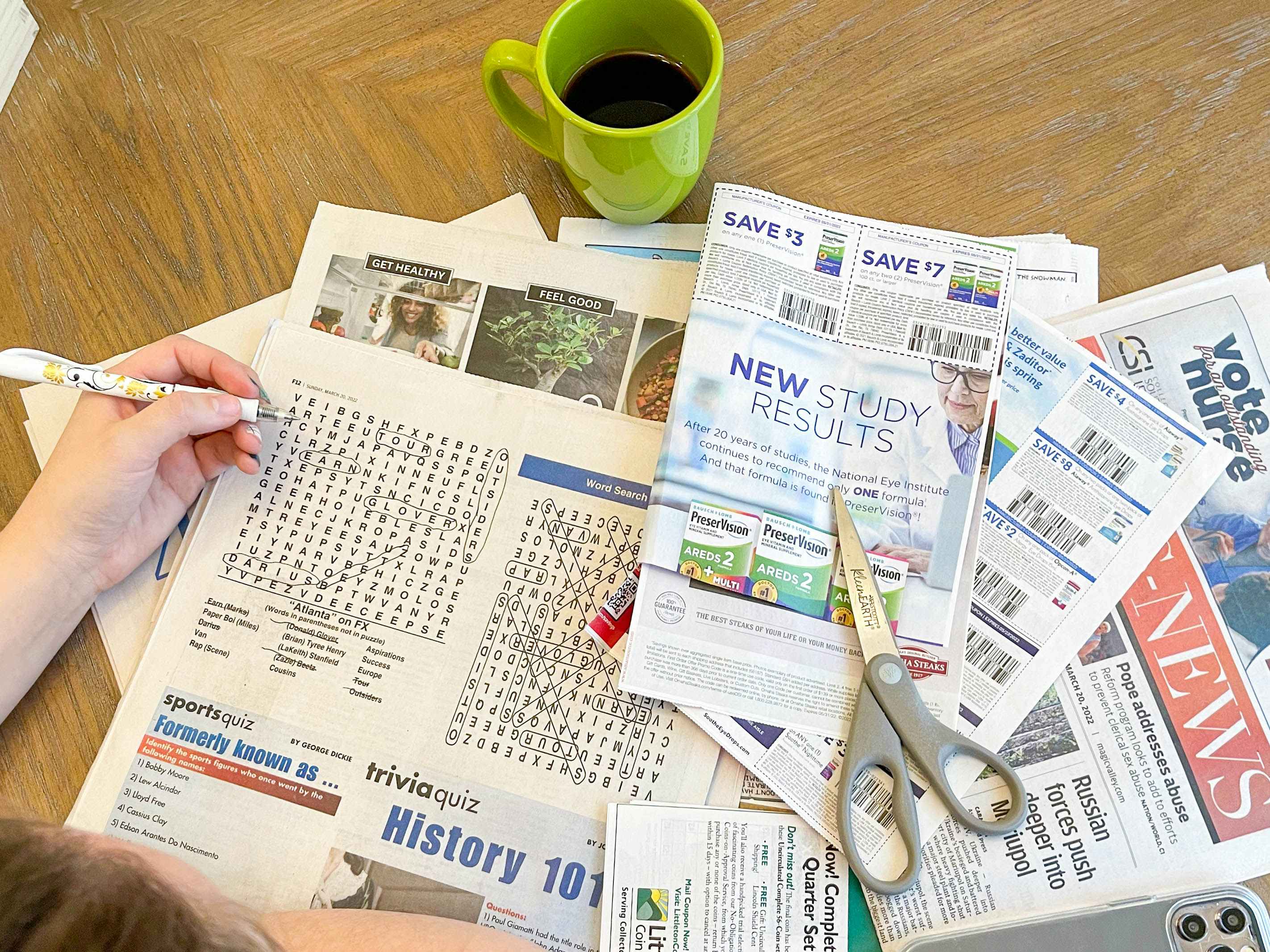 a person doing the crossword puzzle in newspaper