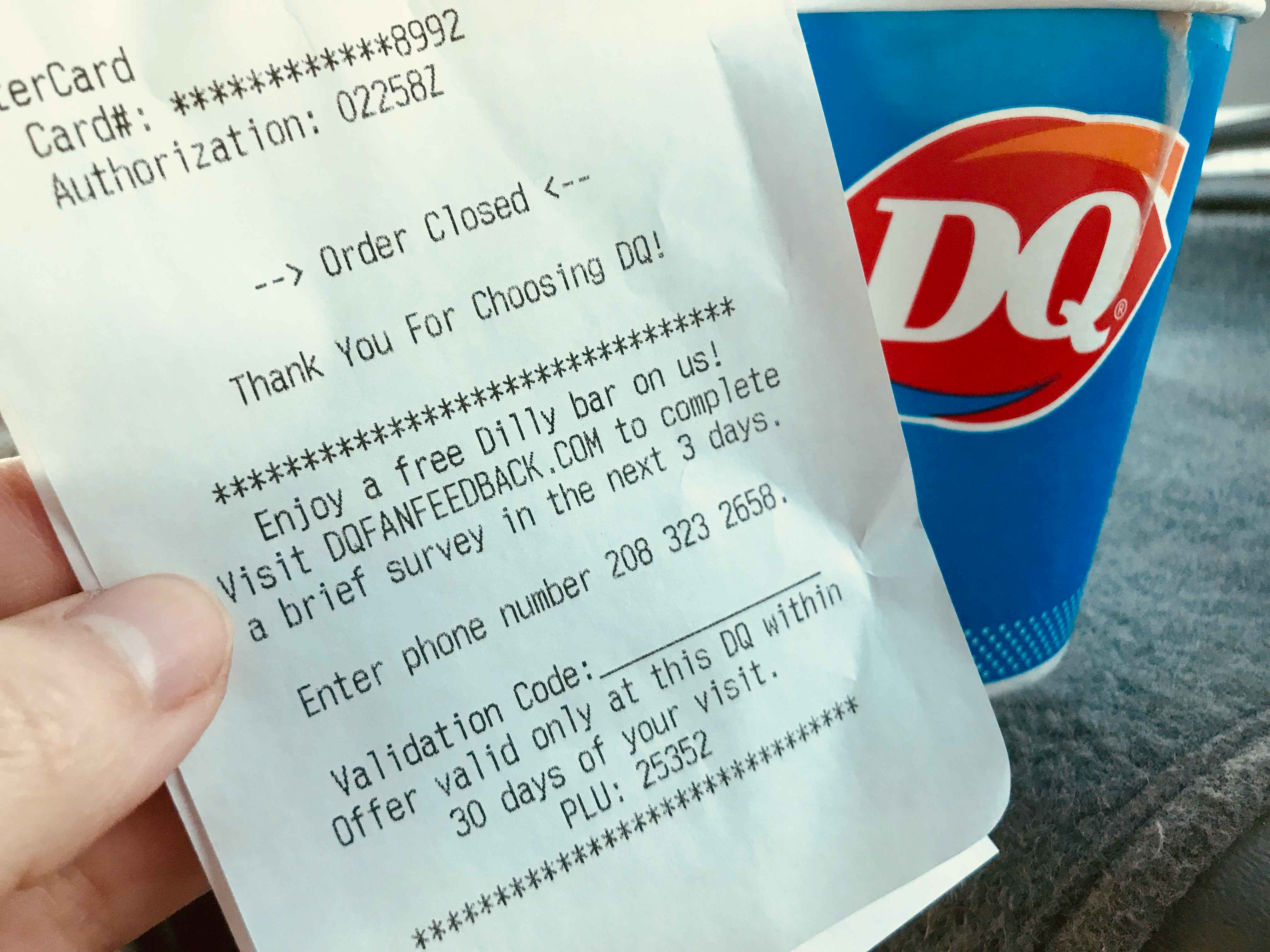 A person holding a Dairy Queen receipt.