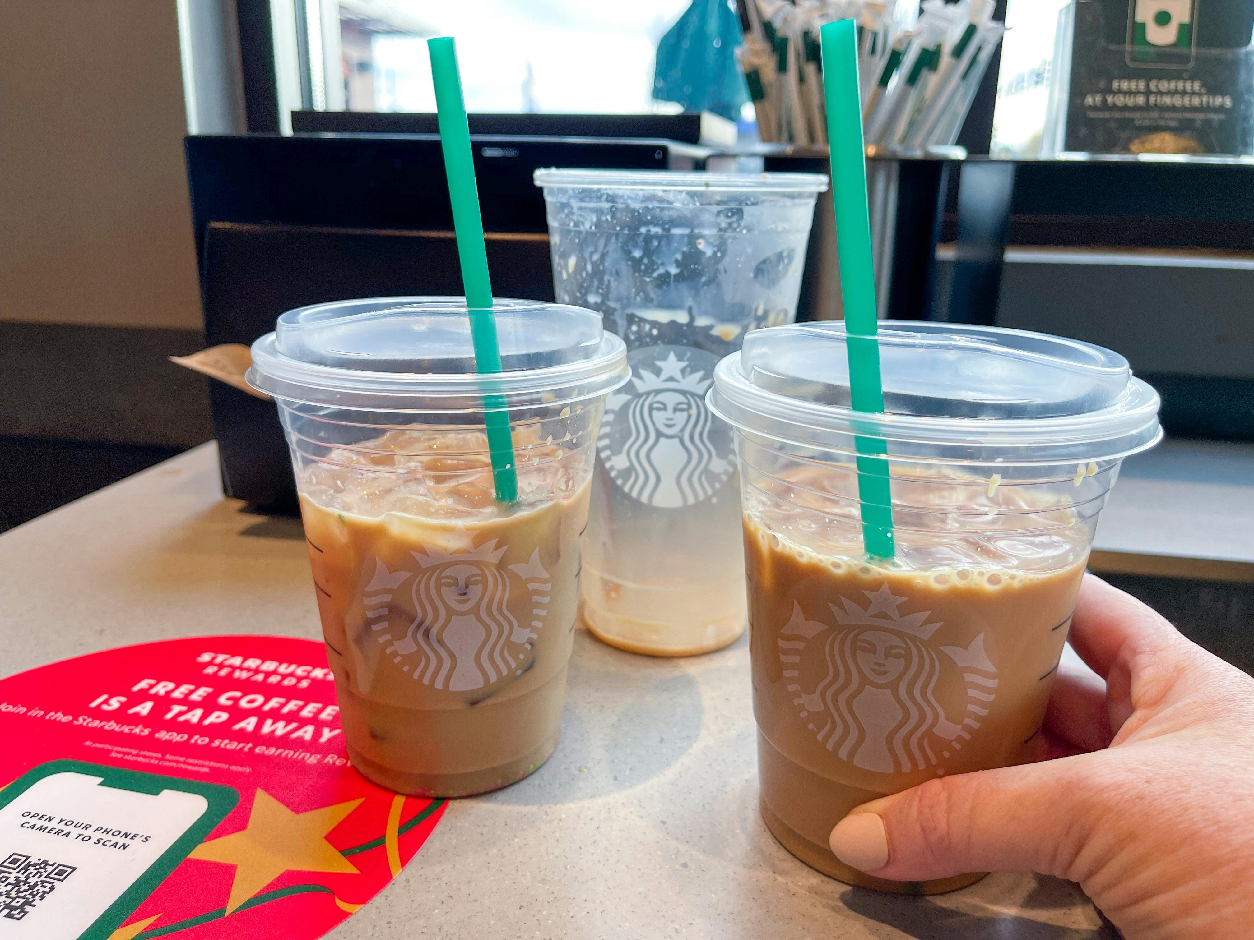 A venti Starbucks iced coffee split into two tall cups.