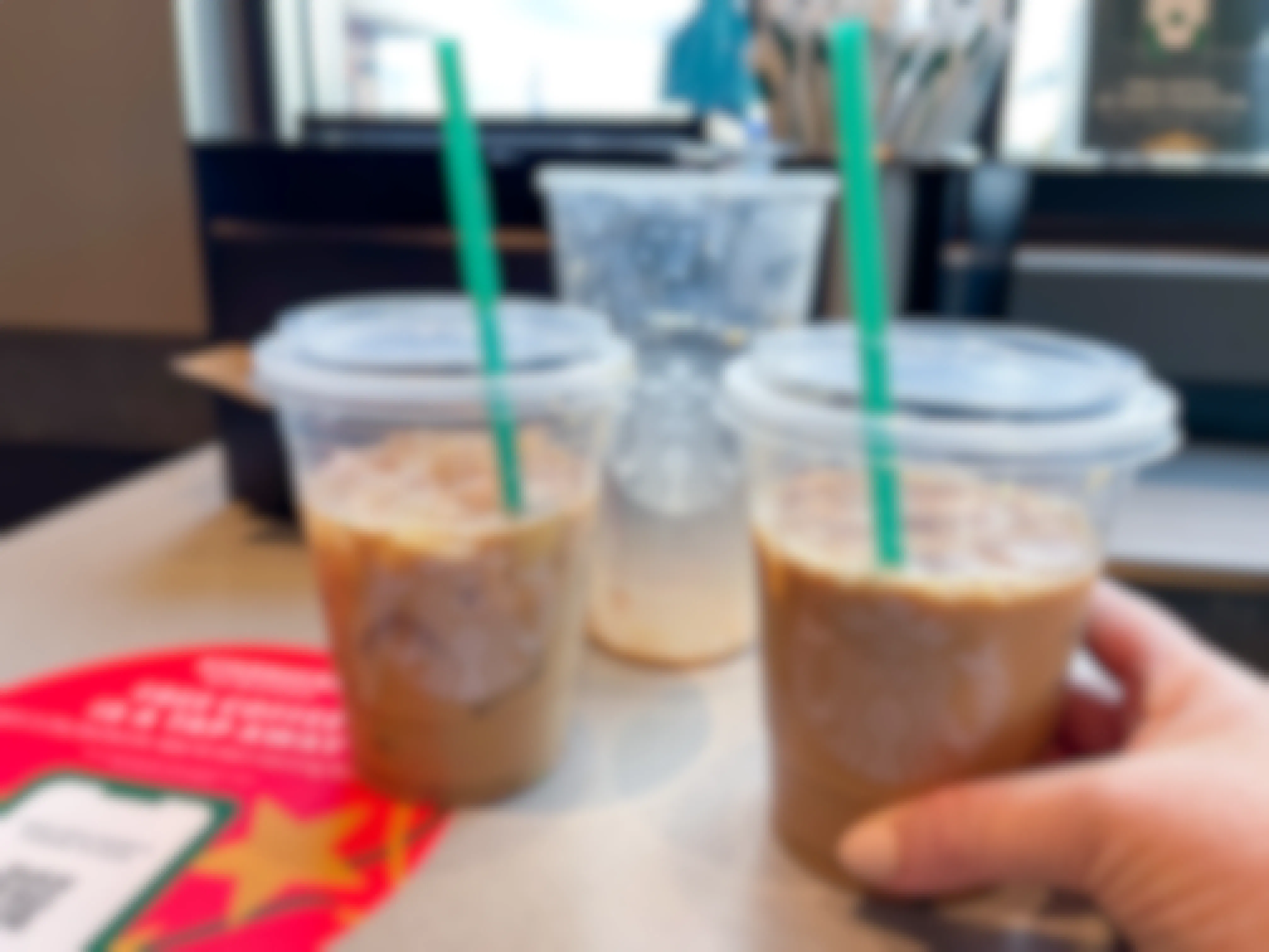 A venti Starbucks iced coffee split into two tall cups.