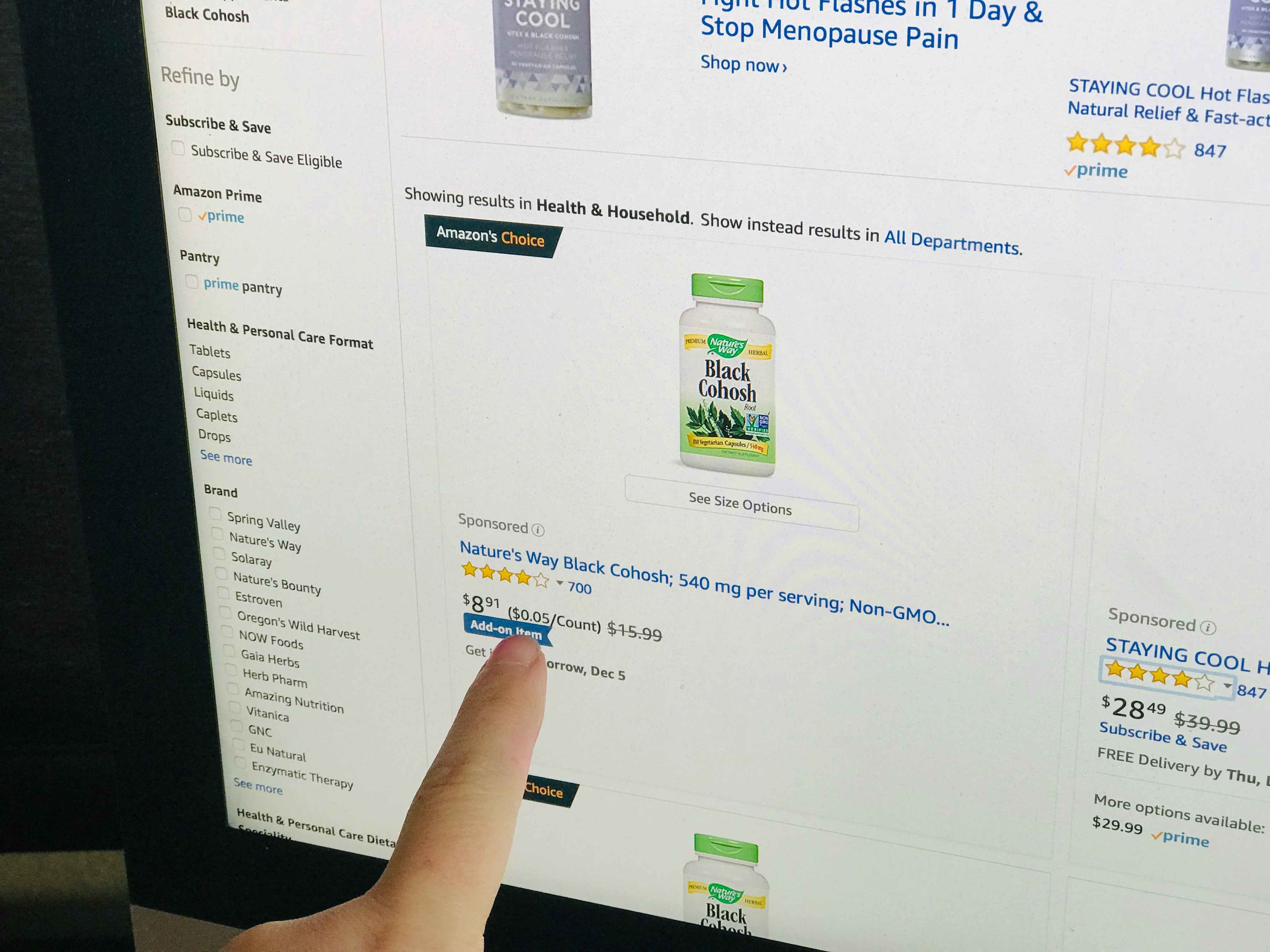 A person pointing out "add-on item" on an amazon webpage screen.