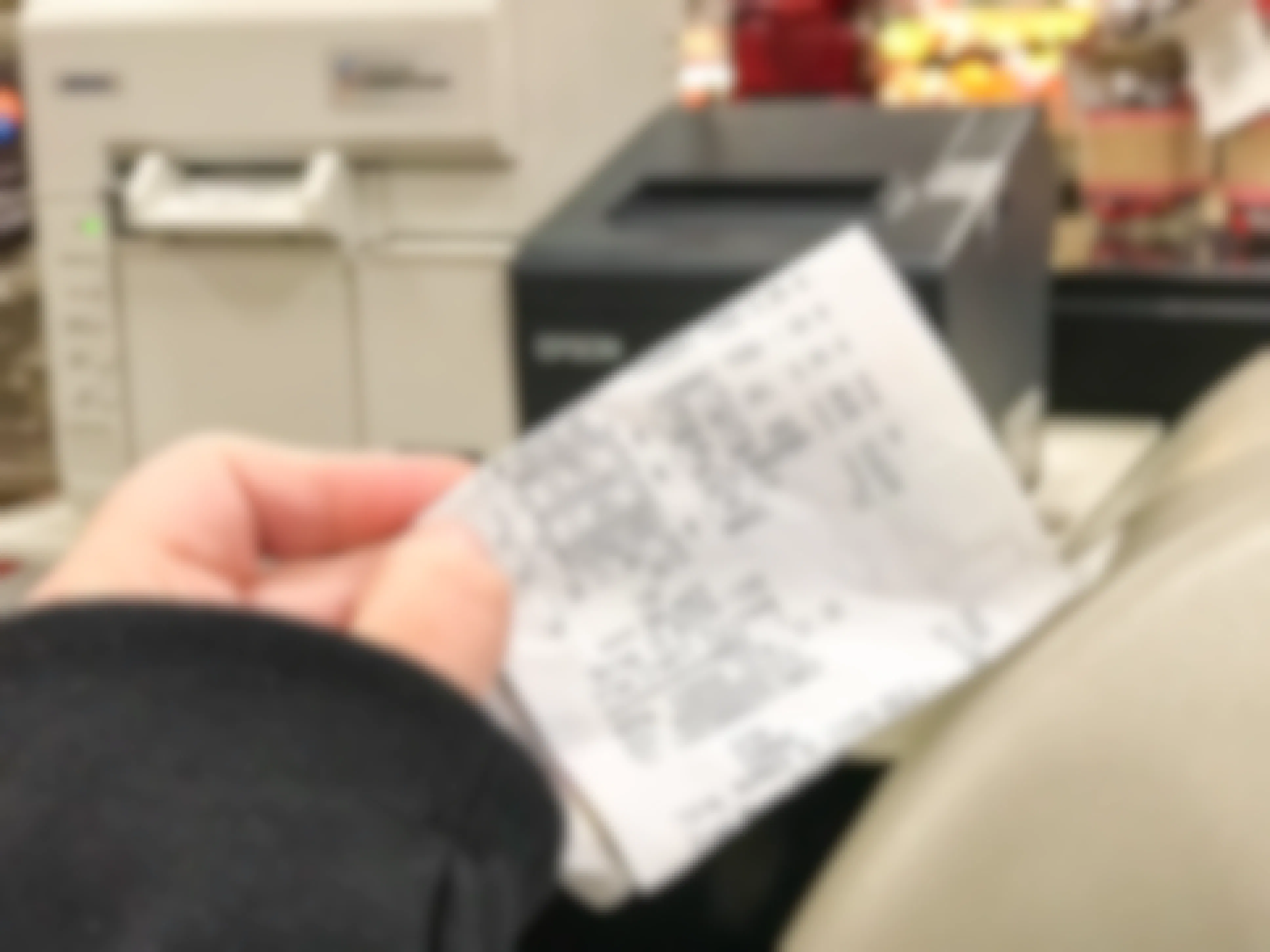 Someone checking their receipt in a store