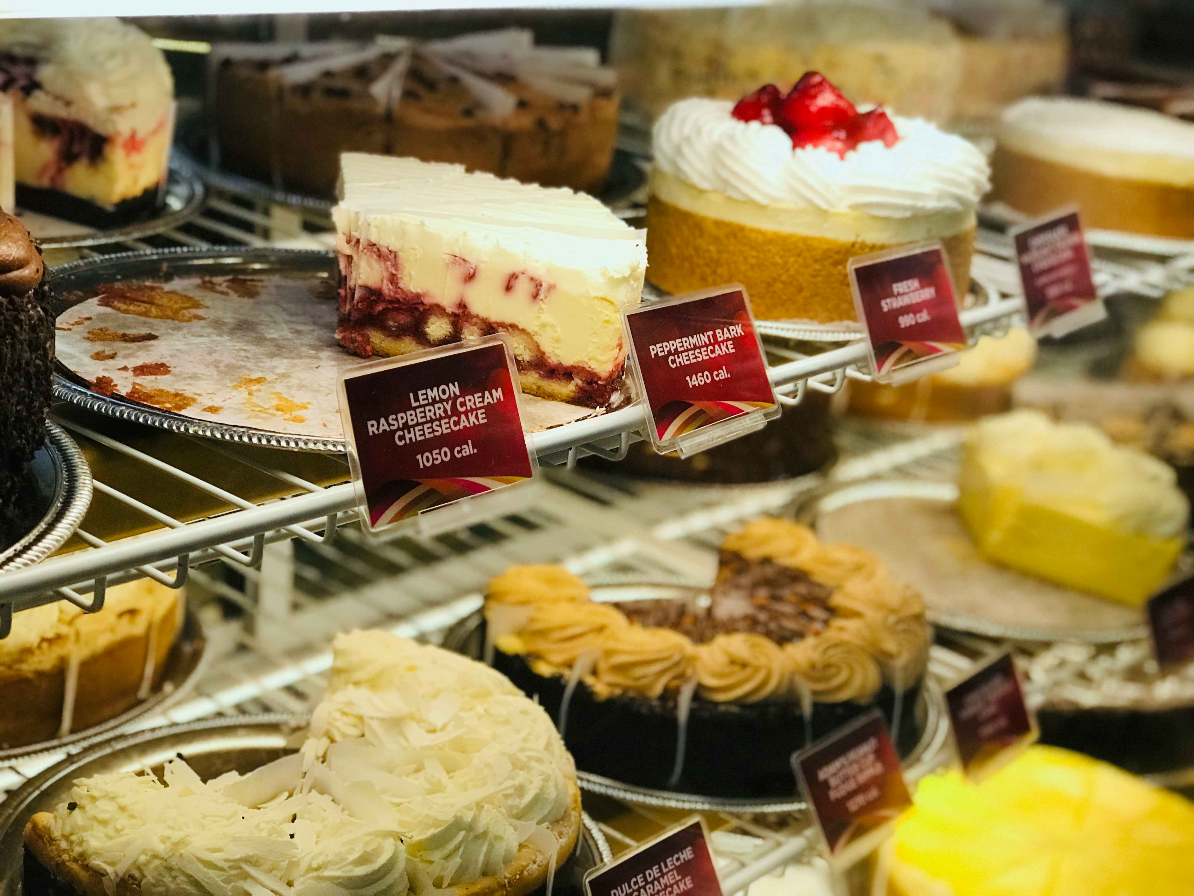 A view of the refrigerated display of cheesecakes available to order at The Cheesecake Factory.