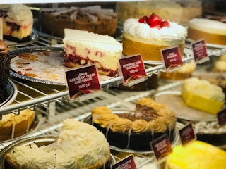 A view of the refrigerated display of cheesecakes available to order at The Cheesecake Factory.