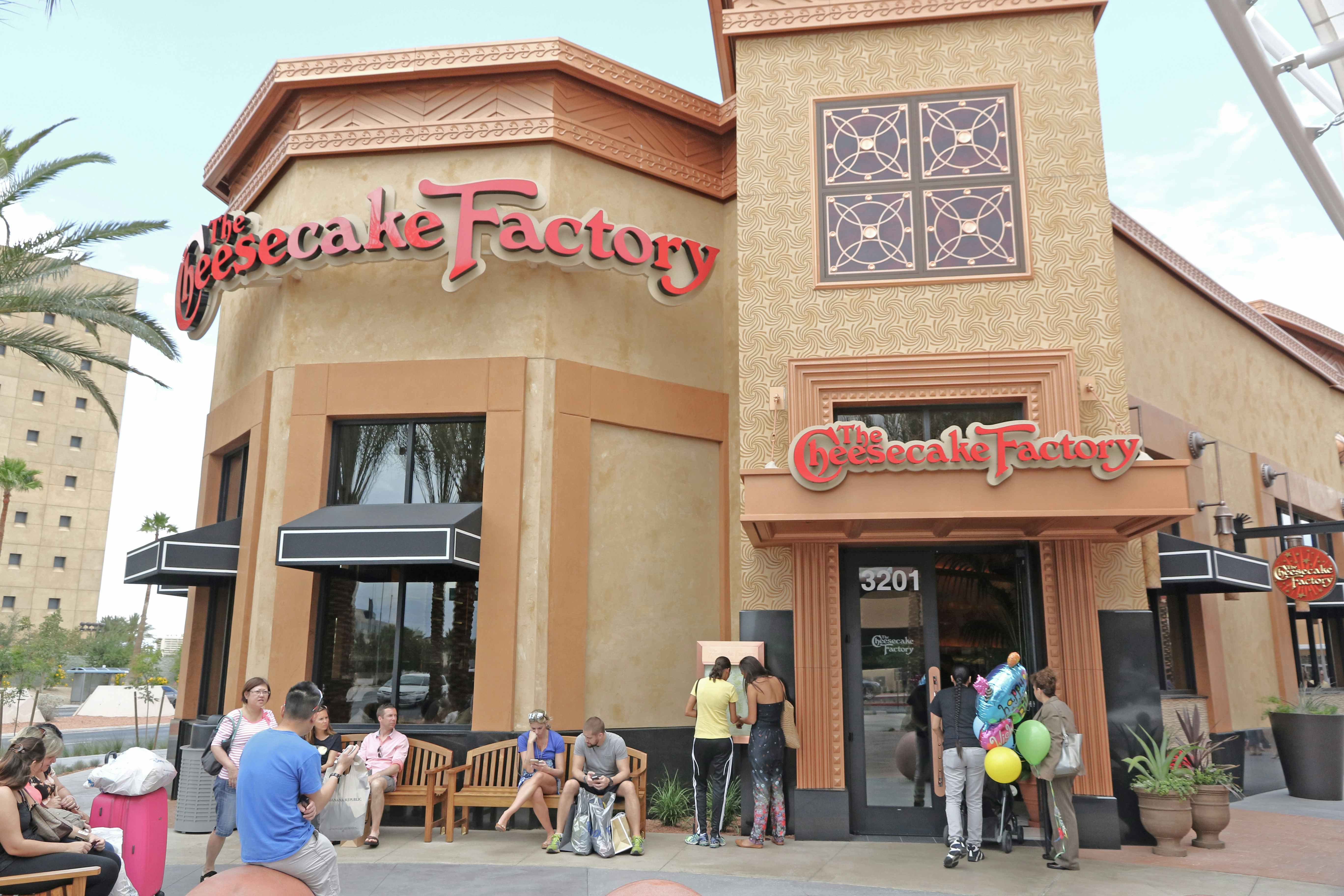 Front side of the Cheesecake Factory restaurant in Las Vegas with people waiting outside to be seated.