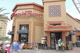 Front side of the Cheesecake Factory restaurant in Las Vegas with people waiting outside to be seated.