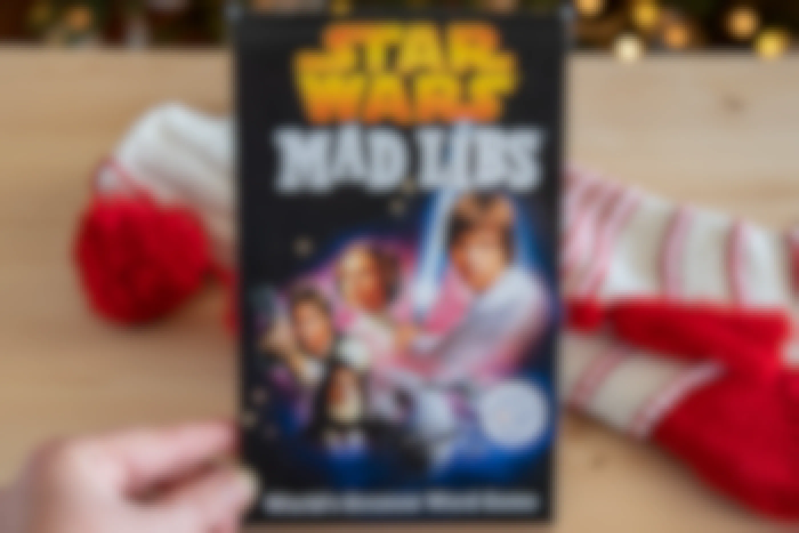 Star Wars Mad Libs book held in front of a Christmas stocking