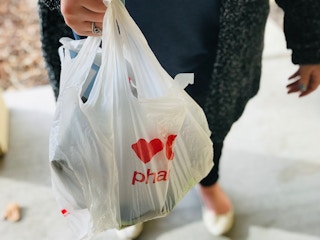 A person holding a CVS bag.