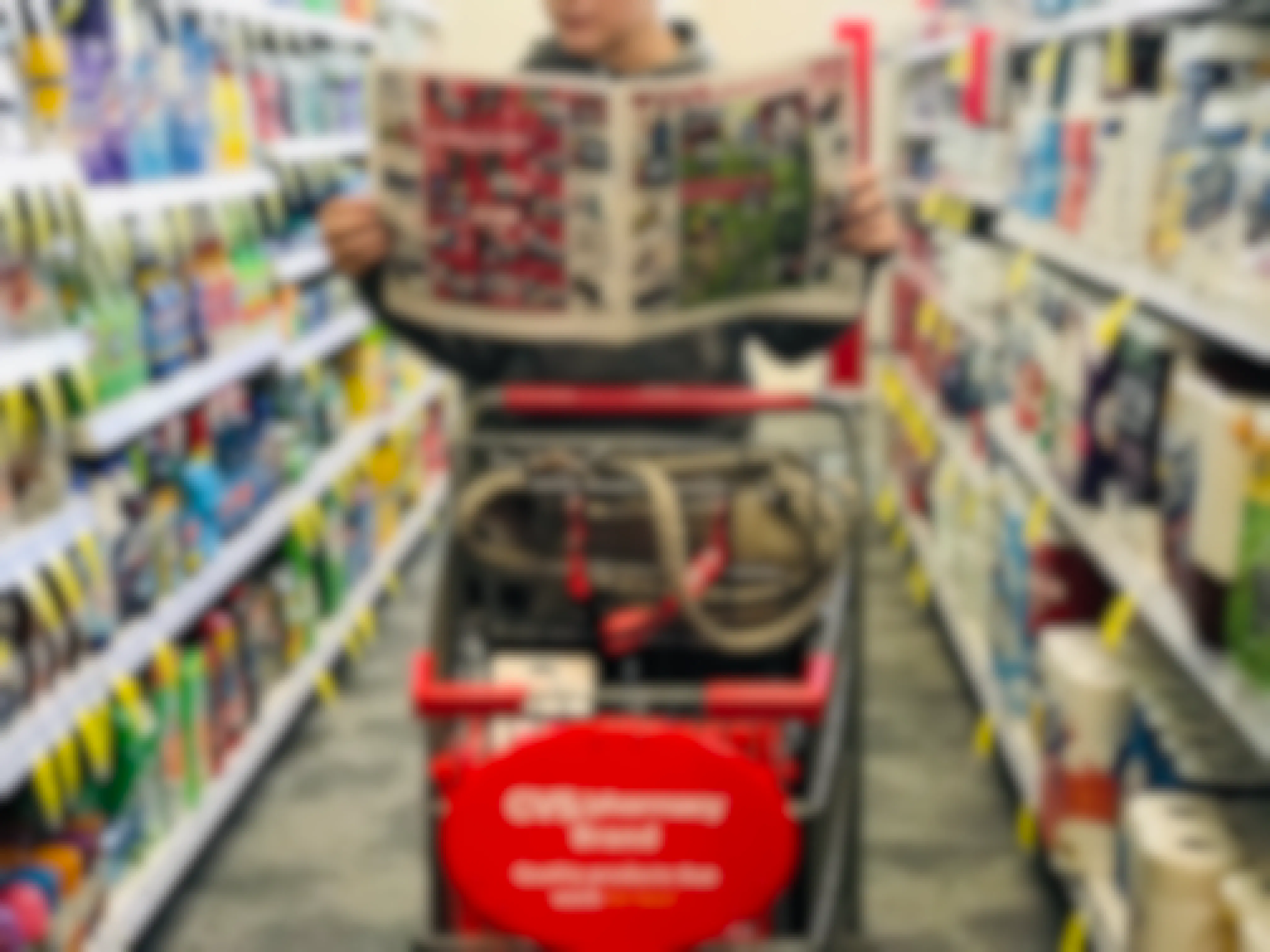 someone holding a cvs ad in front of a cvs cart