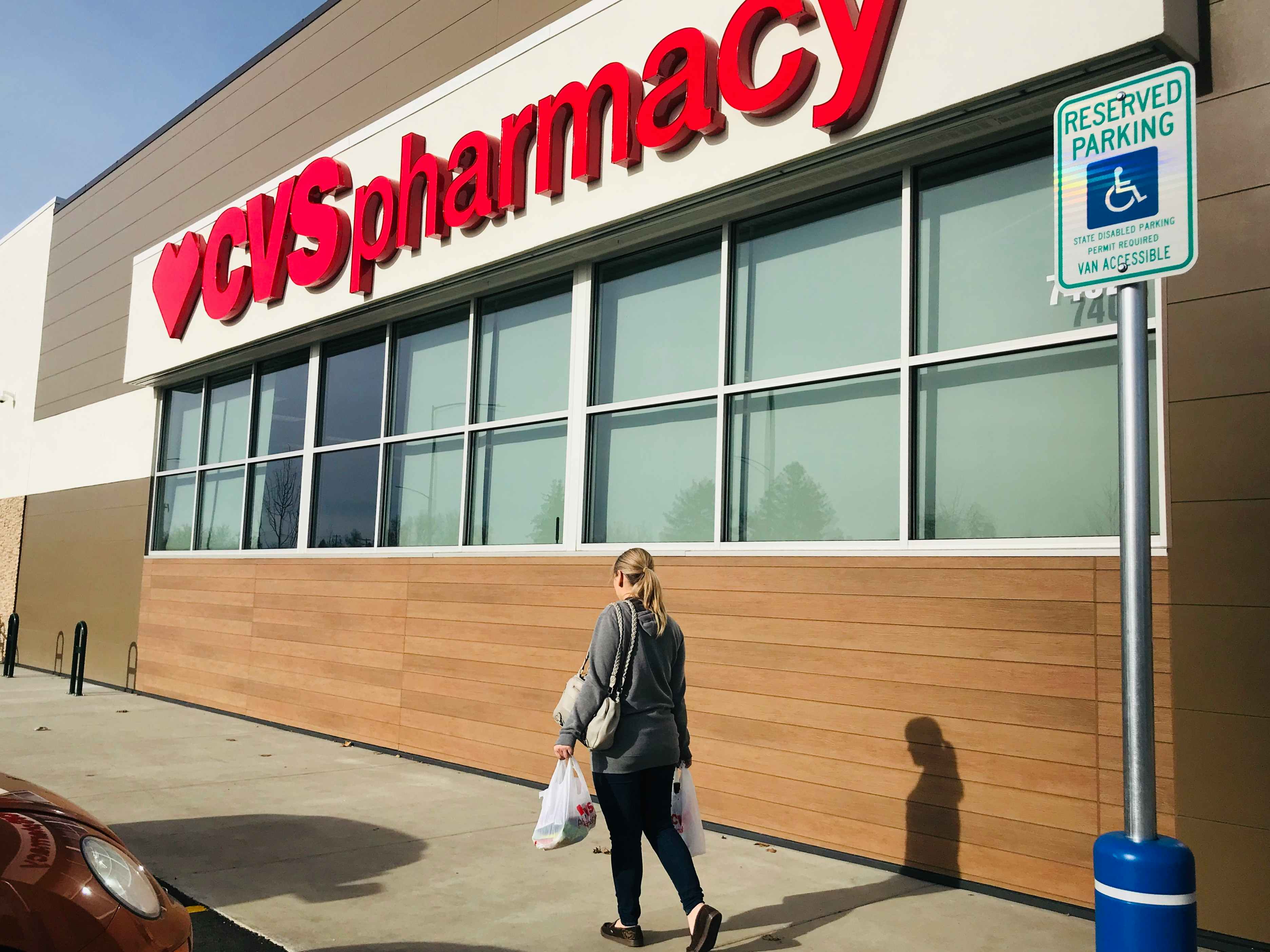 person walking in front of CVS store