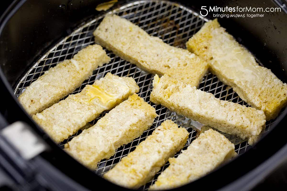 slices of french toast sticks in an air fryer