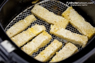 slices of french toast sticks in an air fryer
