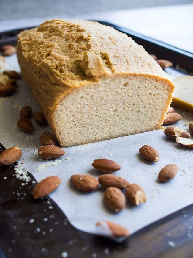 a loaf of keto bread next to almonds