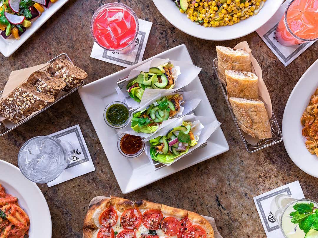 A table filled with food from The Cheesecake Factory.