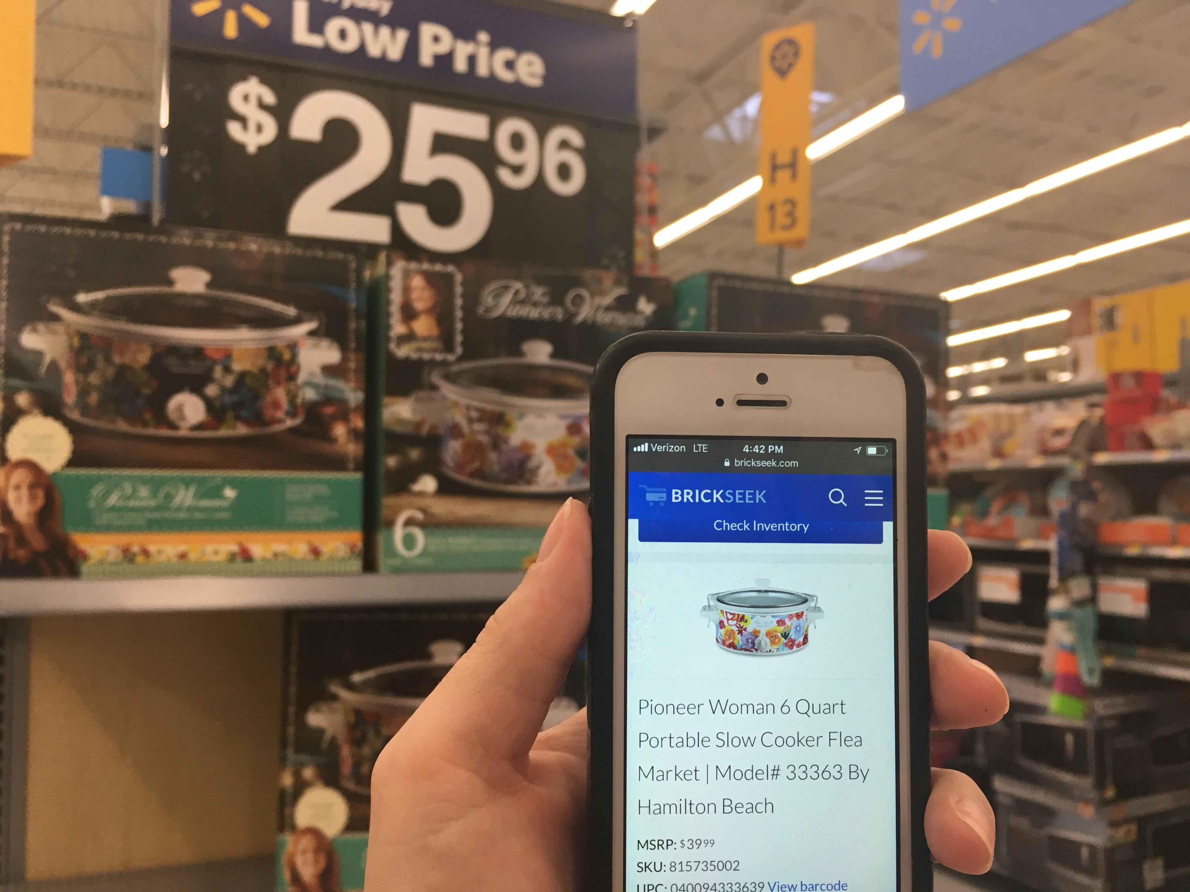 someone holding phone in front of pioneer woman crockpot at walmart