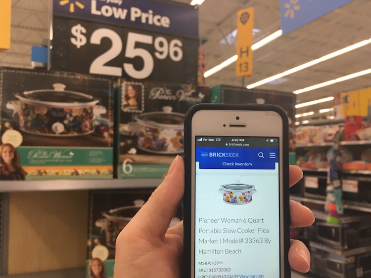 someone holding phone in front of pioneer woman crockpot at walmart