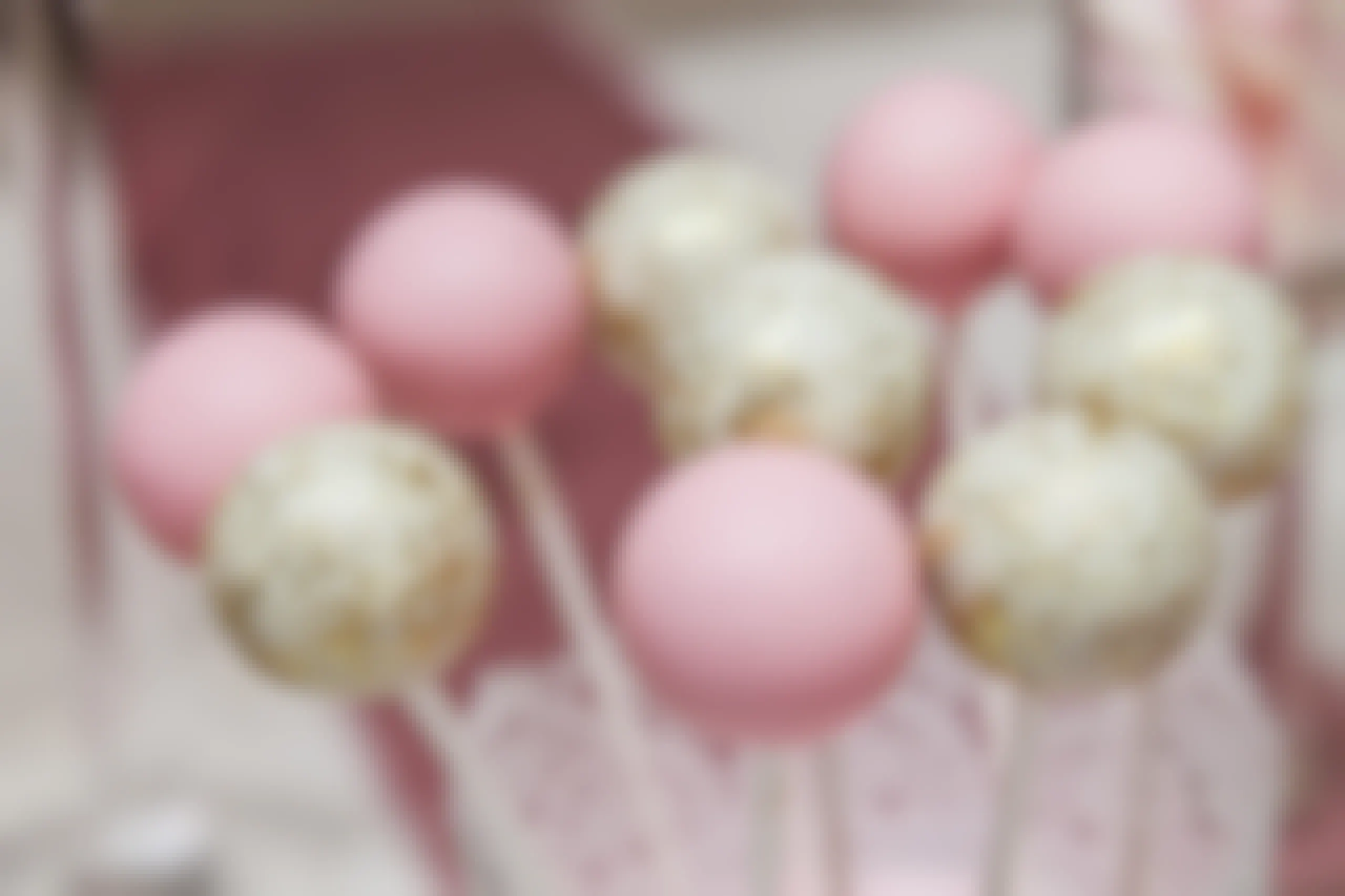Some pink and sparkly white and gold cake pops