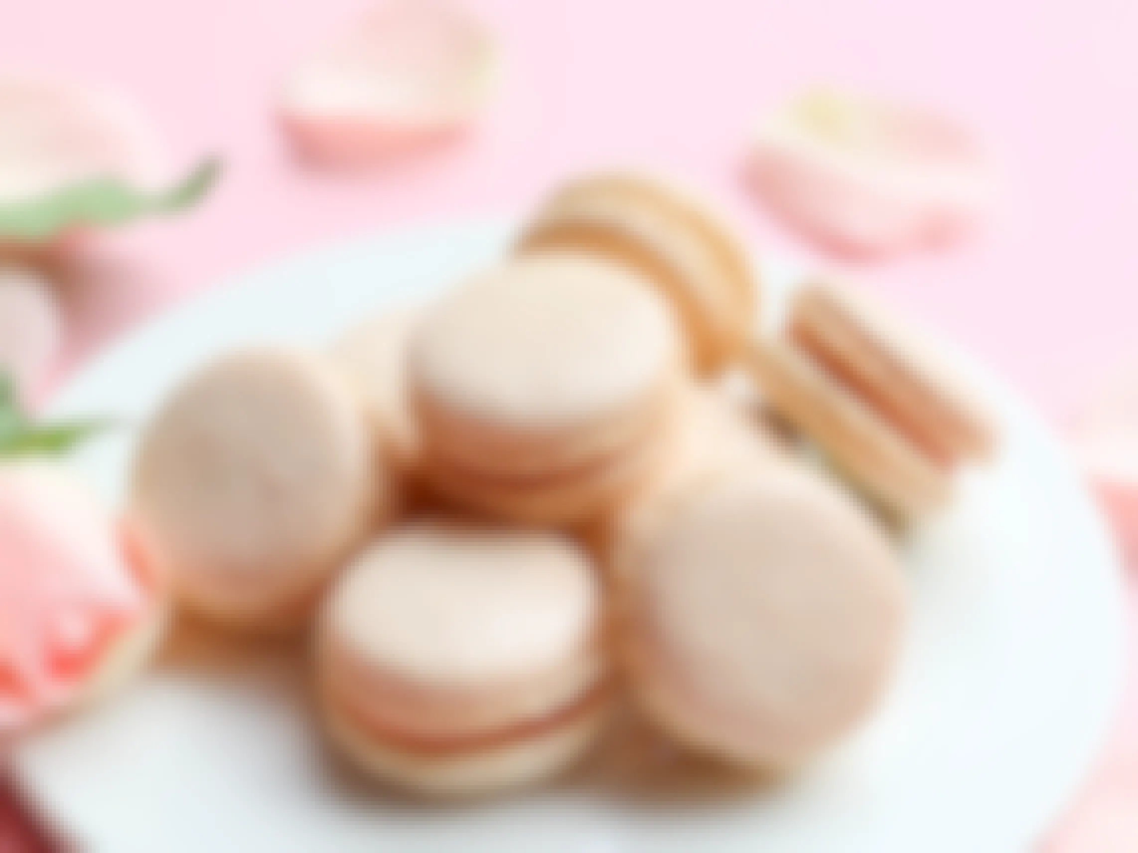 A plate of pastel pink champagne macarons