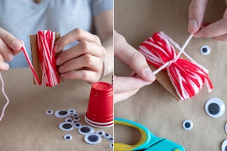 someone winding yarn around cardboard and tying it