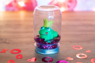 toy frog inide upside down mason jar