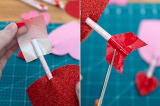 someone putting duct tape on paper straw and cutting lines in it