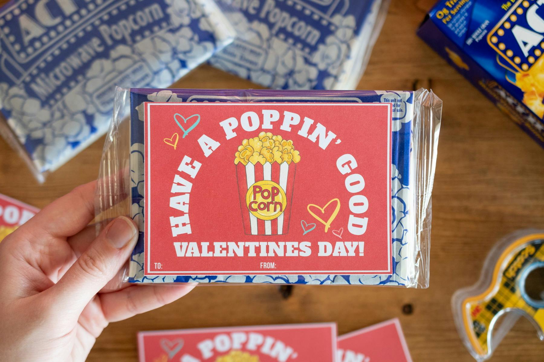 someone holding have a poppin good valentines day card on popcorn