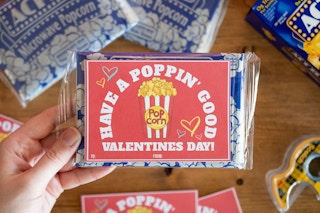 someone holding have a poppin good valentines day card on popcorn