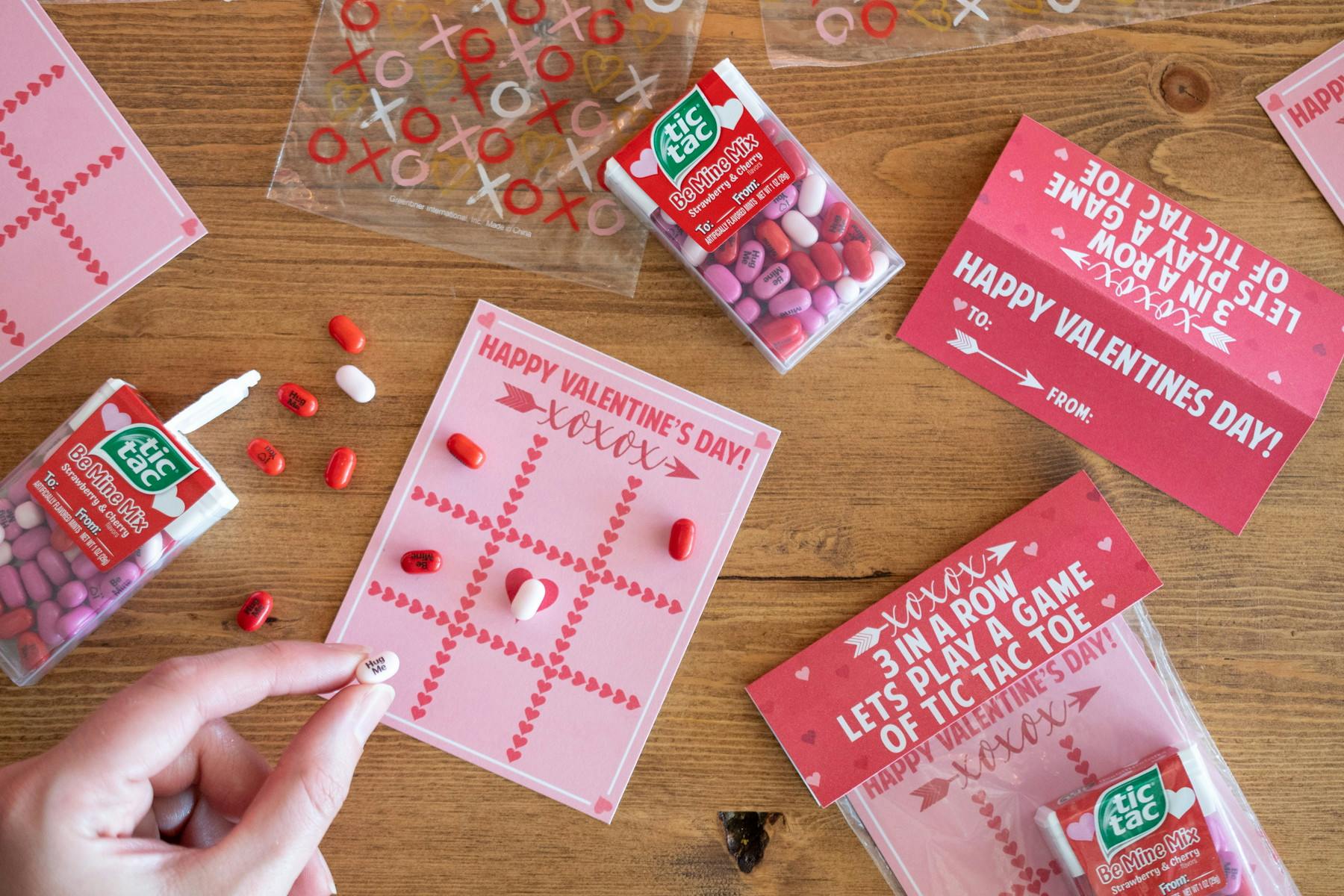 someone using tictacs on a valentines day tic tac toe card