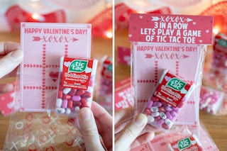 someone holding tic tacs in front of tic tac toe card