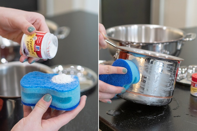 someone pouring cream of tartar on sponge and scrubbing a pot