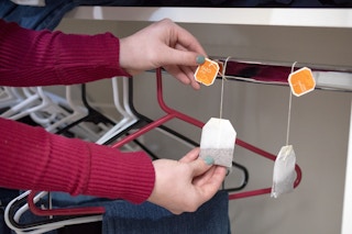 Woman hanging tea bags in a closet