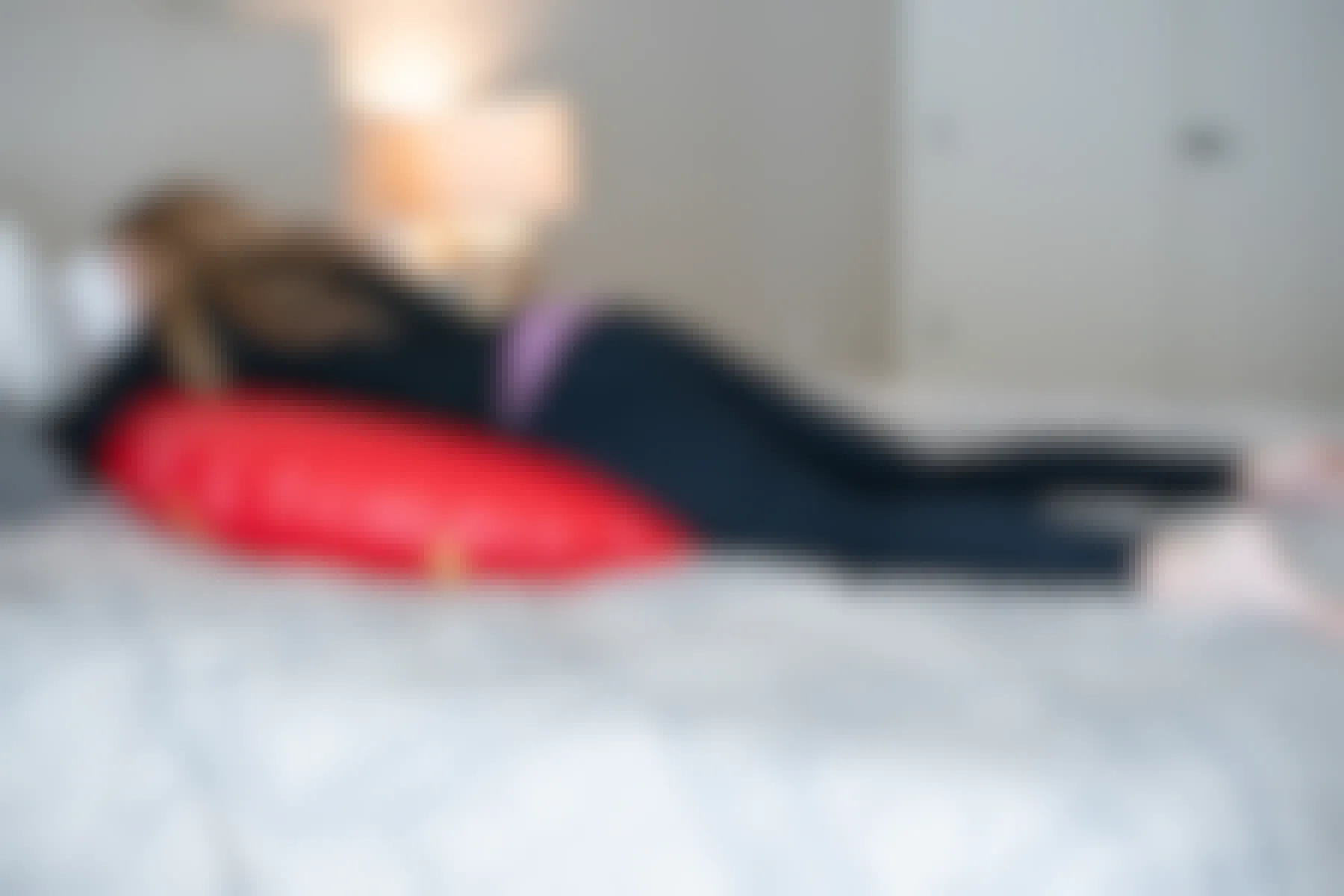 A woman laying down on a inner tube on a bed.
